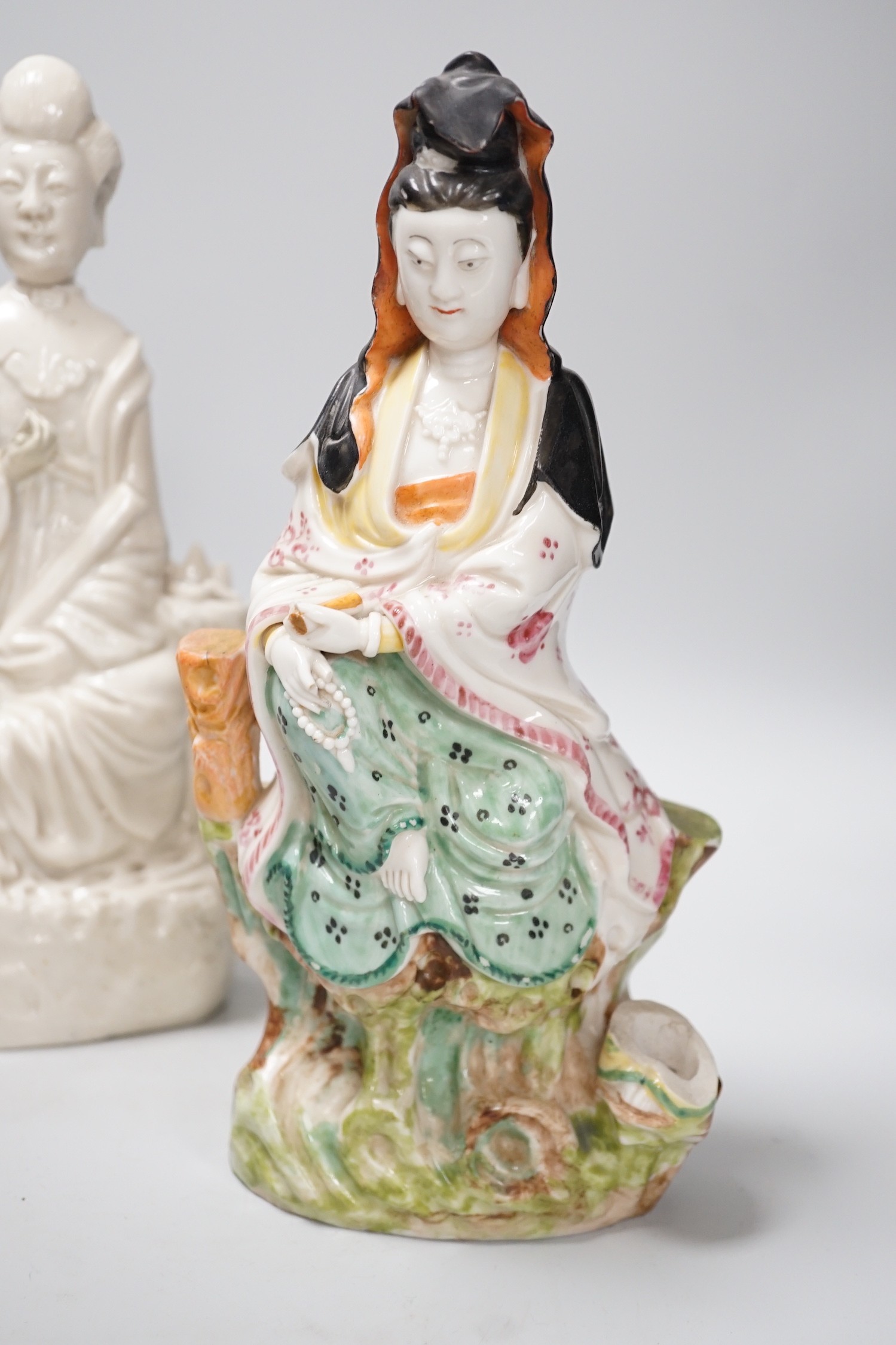 A Chinese enamelled blanc de chine figure of Guanyin, together with three other figures. 28cm tall
